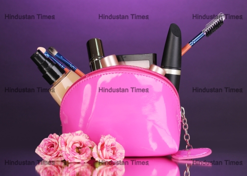 Make,Up,Bag,With,Cosmetics,And,Brushes,On,Violet,Background