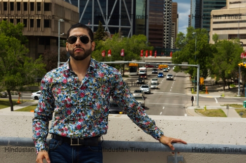 Confident,Looking,Man,In,Sunglasses,And,A,Loud,Shirt,Stands