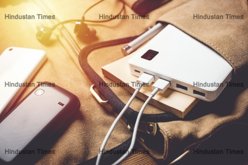 Smartphone,Charging,With,White,Power,Bank.,Close-up,At,White,Power
