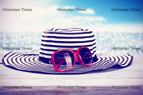 White,Desk,Sea,And,Hat,And,Sunglasses