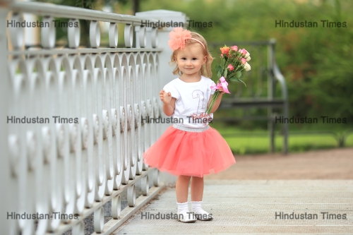 Beautiful,Little,Girl,In,Pink,Skirt,And,Bow,Standing,On