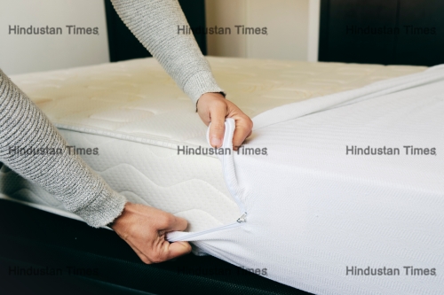 Closeup,Of,A,Young,Caucasian,Man,Covering,A,Mattress,With