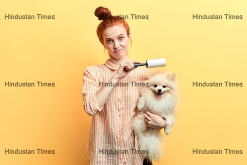 Displeased,Unhappy,Sad,Ginger,Girl,Cleaning,A,Dog,With,A