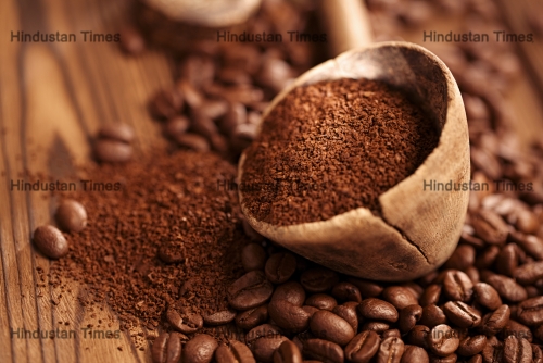 Grated,Coffee,In,Spoon,On,Roasted,Coffee,Beans,Background