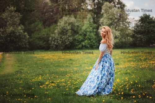 Beautiful,Young,Woman,In,Floral,Maxi,Skirt,Walking,In,Spring