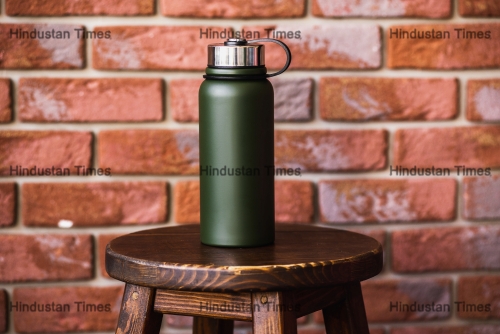 Thermos,Bottle,Near,Brick,Wall,Background.,Coffee,Or,Tea,Reusable