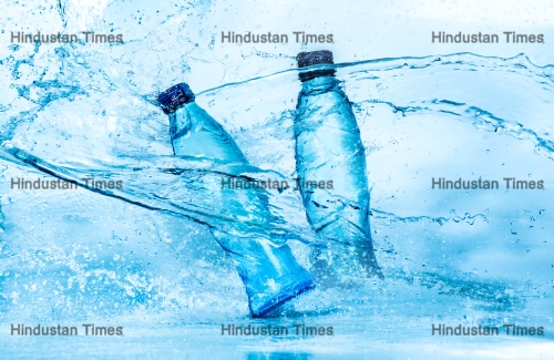 Bottle,Of,Water,Splash,On,A,Blue,Background