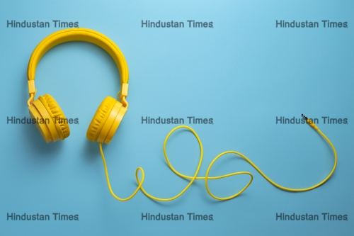 Yellow,Headphones,On,Blue,Background.,Music,Concept.