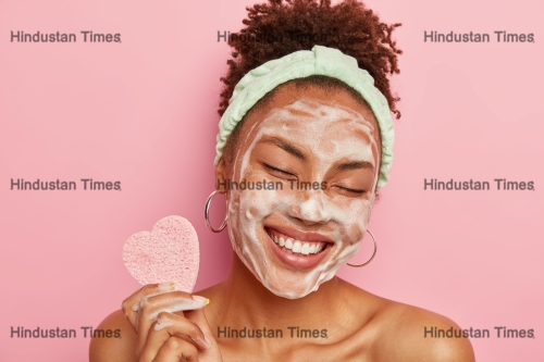 Beautiful,Optimistic,Afro,American,Woman,Cleanses,Face,With,Foam,,Refreshes