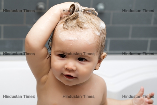 Small,Curious,Pretty,Baby,Boy,Sitting,In,White,Bathroom,With