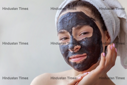 Woman applying mask on face