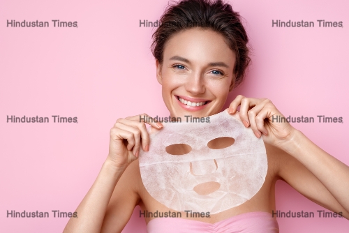 Smiling,Woman,Holds,Facial,Sheet,Mask.,Photo,Of,Attractive,Woman