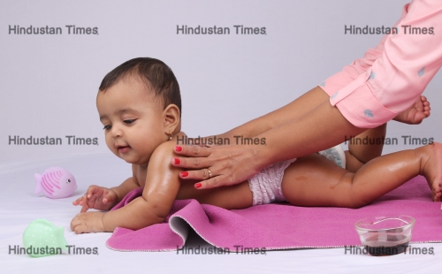 Indian,Mother,Massaging,Her,Lovely,Baby.