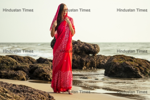 Young,Women,Wearing,A,Red,Saree,On,The,Beach,Goa