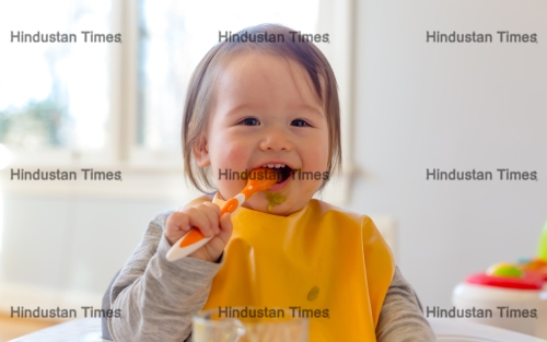 Happy,Toddler,Boy,Smiling,While,Eating,A,Meal