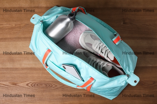 Open,Sports,Bag,Full,Of,Gym,Stuff,On,Wooden,Background,