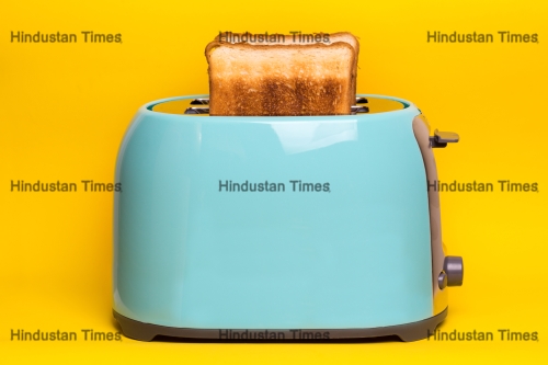 Bright,,Fun,Breakfast.,Cyan,Color,Toaster,On,A,Yellow,Background