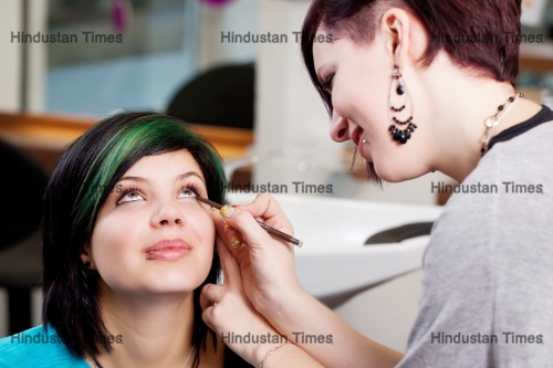 Young,Make-up,Artist,Applying,Kajal,On,Clients,Eyes
