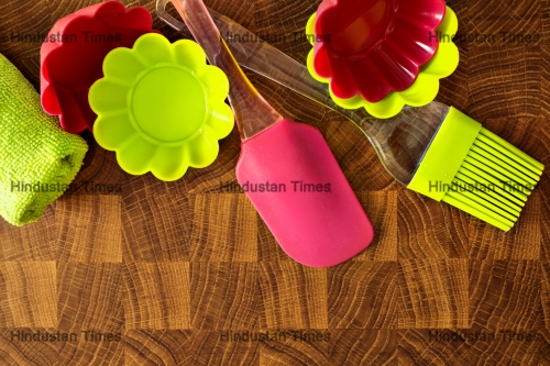 Silicone,Whisk,,Spatula,,Brush,And,Cupcake,Liners,On,Wooden,Table