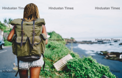 Back,View,Of,African,American,Female,Tourist,With,Backpack,Exploring