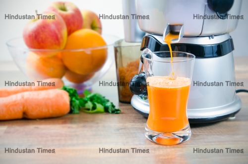 Juicer,And,Carrot,Juice.,Fruits,In,Background