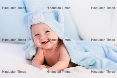 Baby,Boy,Wearing,Diaper,And,Blue,Towel,In,White,Sunny