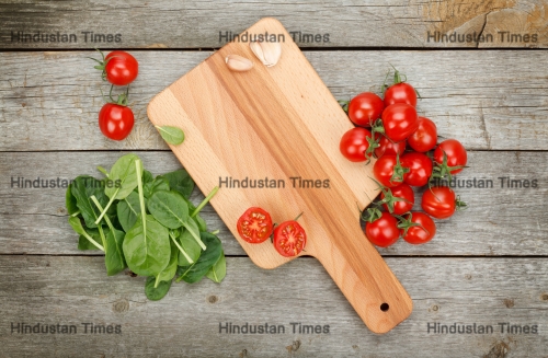 Cherry,Tomatoes,On,Cutting,Board,Over,Wooden,Table,Background