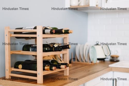 Wooden,Wine,Supply,With,Bottles,On,Table,In,Modern,Kitchen.