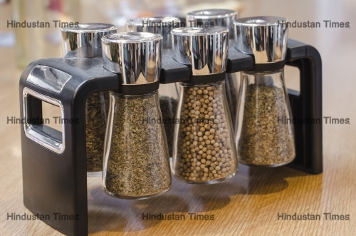 A,Stand,Of,Different,Bottles,Of,Spices,On,Wooden,Background