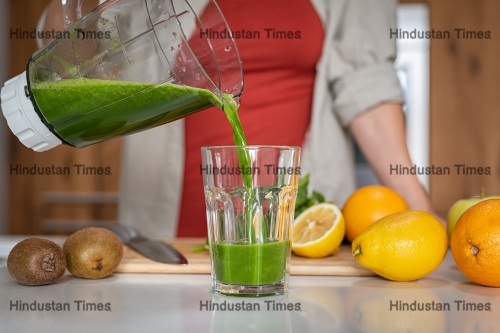 Close,Up,Of,Young,Healthy,Woman,Pouring,Fresh,Juice,In