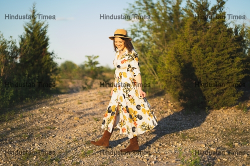 Woman,Walking,In,A,Field,At,Sunset,Wearing,Bohemian,Style