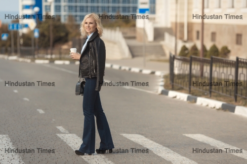 Beautiful,Blonde,Woman,Cross,The,Road,With,A,Take,Away