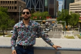 Confident,Looking,Man,In,Sunglasses,And,A,Loud,Shirt,Stands