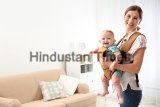 Woman,With,Her,Son,In,Baby,Carrier,At,Home.,Space