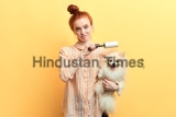 Displeased,Unhappy,Sad,Ginger,Girl,Cleaning,A,Dog,With,A