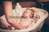 Small,Baby,First,Bathing,On,Mothers,Hands