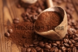 Grated,Coffee,In,Spoon,On,Roasted,Coffee,Beans,Background
