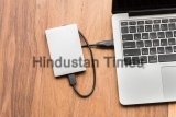 External,Hard,Drive,Connect,To,Laptop,Computer,On,Wooden,Background