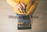 Woman,Entrepreneur,Using,A,Calculator,With,A,Pen,In,Her