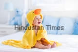 Happy,Laughing,Baby,Wearing,Yellow,Hooded,Duck,Towel,Sitting,On