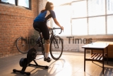 Asian,Woman,Cyclist.,She,Is,Exercising,In,The,House.by,Cycling