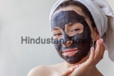 Woman applying mask on face