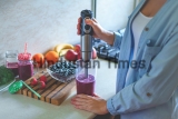 Woman,Cooking,Fresh,Blueberry,Smoothie,With,Hand,Blender,At,Kitchen