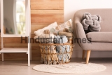 Basket,With,Blankets,And,Pillows,Near,Sofa,Indoors