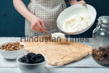 Woman,Spreads,Whipped,Sweet,Cream,On,Meringue,Cake,On,A