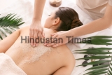 Young,Woman,Undergoing,Treatment,With,Body,Scrub,In,Spa,Salon