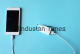Close,Up,White,Smartphone,Plug,In,With,Charger,Adapter,On