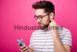 Hnadsome,Aman,Wearing,Glasses,,Using,Airpods,,Over,Isolated,Pink,Packground
