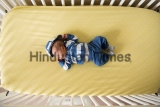 Aerial,View,Of,Newborn,Baby,Boy,In,Blue,Outfit,In