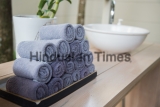 Rolled,Towels,In,Wooden,Tray,At,Clean,Bathroom
